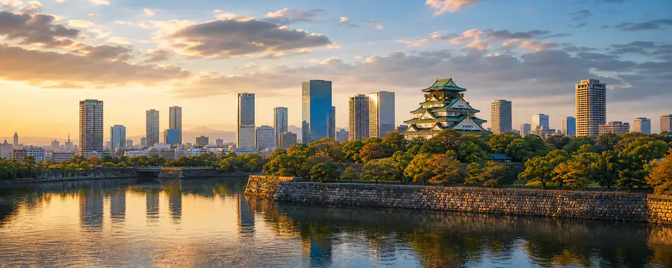 Illustrated view of Osaka Castle with a modern city skyline, moat, and reflections in warm evening light